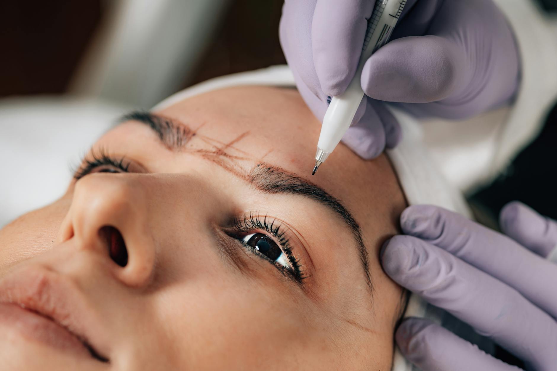 Precise microblading procedure creating natural-looking eyebrow strokes